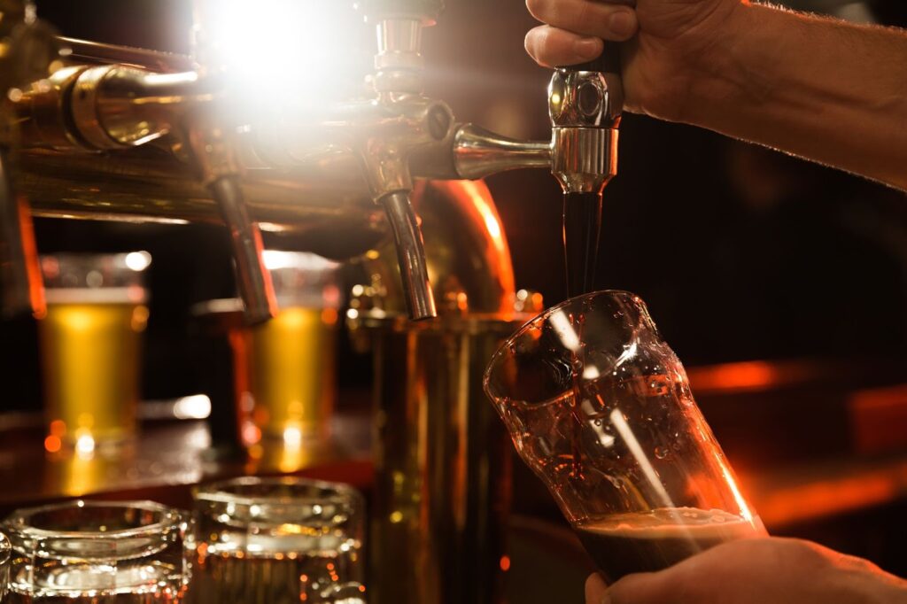 a bartender pouring beer