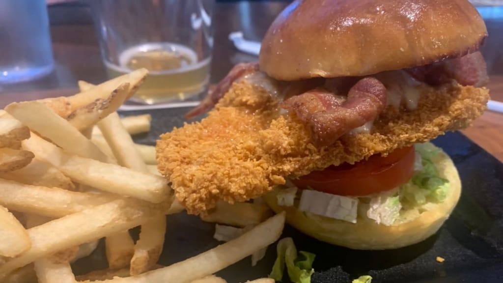 A crispy chicken burger with fries served at Tavern in the Square