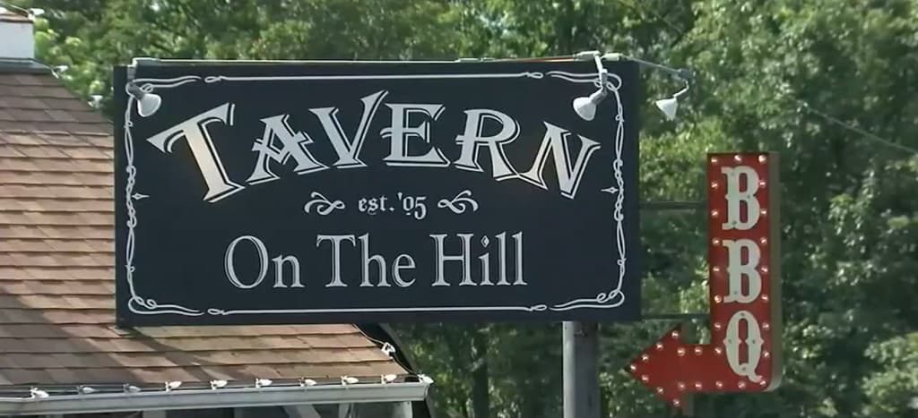 Signboard of 'Tavern On The Hill' with a BBQ arrow sign