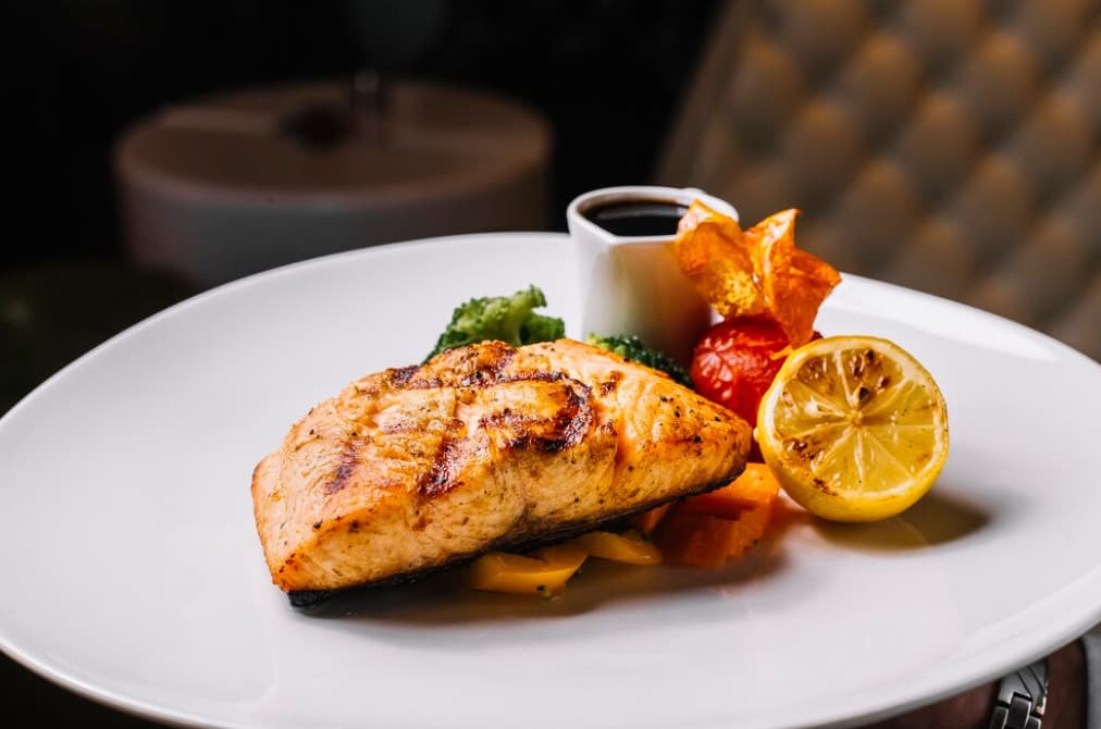 Grilled chicken breast with lemon and vegetables on a plate
